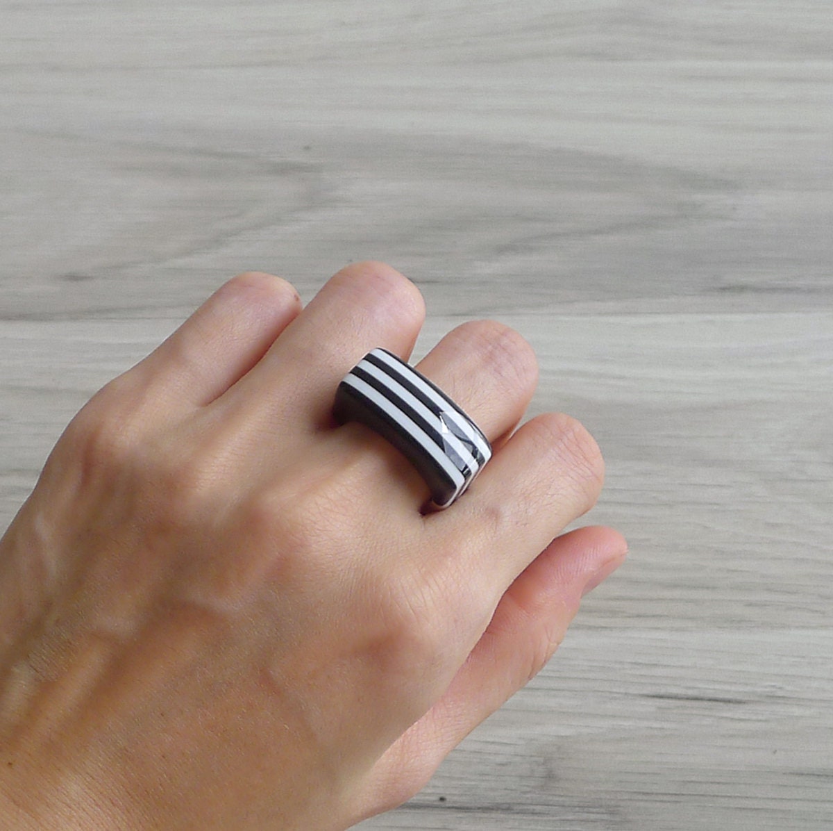 Steel ring with a thin black stripe and half moons – buy at Poison Drop  online store, SKU 51583.