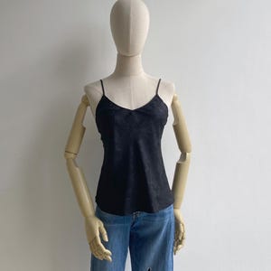 Front view of a 90s vintage black camisole top with a v-neck, babydoll flare fit & slim shoulder straps
