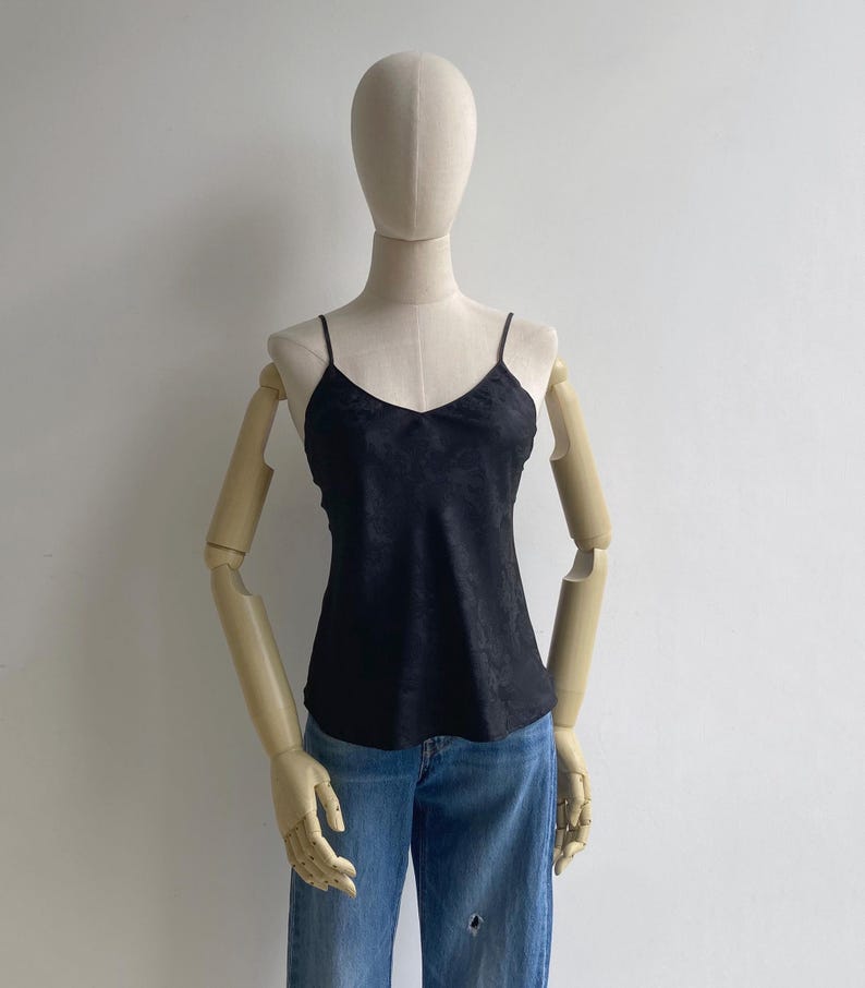 Front view of a 90s vintage black camisole top with a v-neck, babydoll flare fit & slim shoulder straps