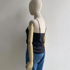 Back view of a silky black camisole tank with straight back & adjustable slim shoulder straps