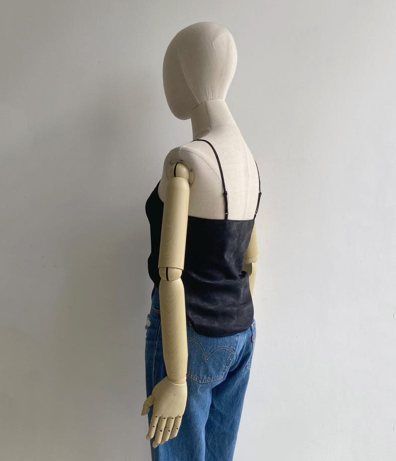 Back view of a silky black camisole tank with straight back & adjustable slim shoulder straps