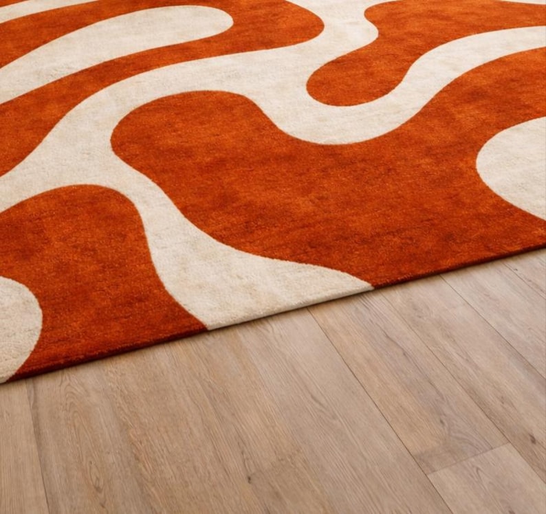 Close-up of the thick, soft texture of the Hand Tufted Wool Rug showing the premium quality material and detailed Wavy Abstract stitching in Burnt Orange.