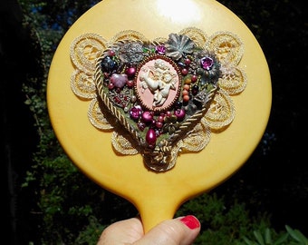 SALE 1930s Celluloid Cherub Hand Mirror "Cherubs Playing in the Arbor" Lace Heart, Rose Pearls, Flowers Beads, Hearts. Cherub Mirror 89.90