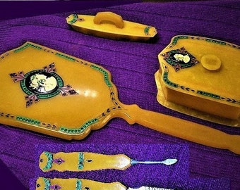 1920s Celluloid Cameo Long Hand Mirror w/ Bacchante w/ Grapes in Hair on Rhinestones of Purple, Emerald on Butterscotch 6 Piece Dresser Set