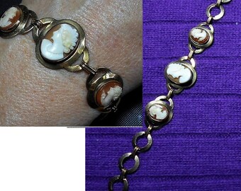 May include: A gold chain bracelet with four cameo medallions. The medallions are oval shaped and feature white cameo portraits on a brown background.