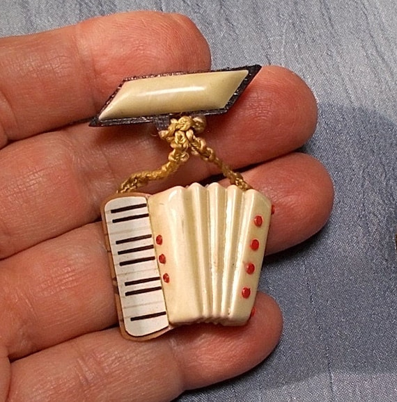 1920 Celluloid Dangling Accordion Bar Brooch.  Co… - image 1