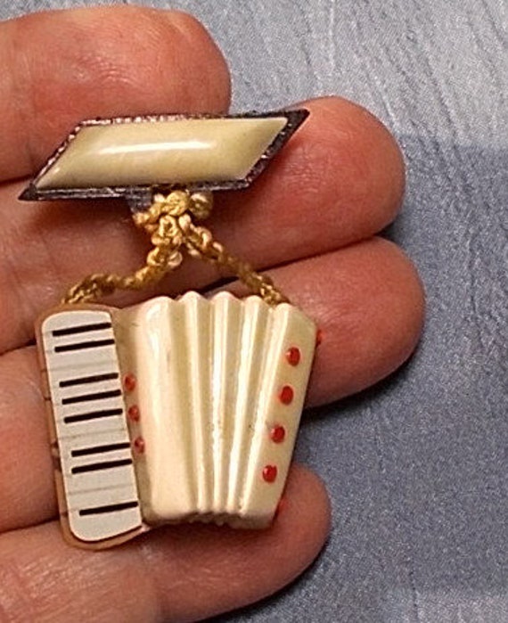 1920 Celluloid Dangling Accordion Bar Brooch.  Co… - image 2