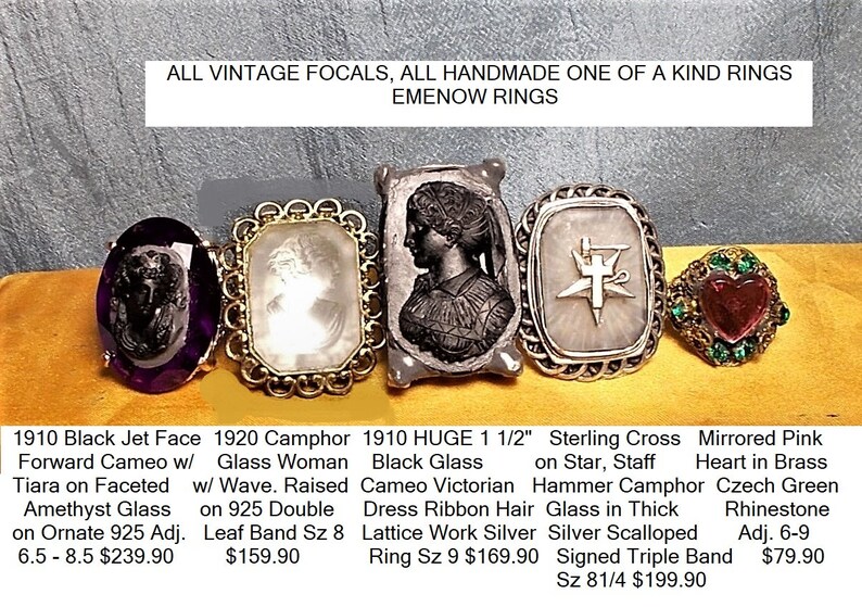 May include: Five vintage rings with different designs and gemstones. The rings feature a black jet face cameo, a camphor glass woman cameo, a black glass cameo Victorian, a sterling silver cross on a star, and a mirrored pink heart in brass with Czech green rhinestones.