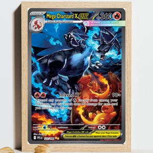 May include: A framed trading card featuring Mega Charizard X with 360 HP. The artwork displays a large blue-flamed dragon-like creature above smaller orange fire-breathing creatures. Text includes Mega Charizard X, Inferno X, and 90x damage.
