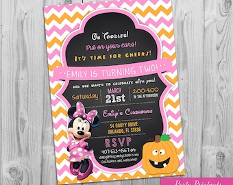 May include: A pink and orange chevron patterned invitation for a birthday party. The invitation features a cartoon image of Minnie Mouse and a pumpkin. The text on the invitation reads "Oh Toodles! Put on your ears! It's time for cheers! Emily is turning two! ... and she wants to celebrate with you! Saturday, March 21st, 2:00-4:00 in the afternoon. Emily's Clubhouse, 54 Goofy Drive, Orlando, FL 32836. RSVP 407-123-4567 or daisy@thepartystork.com. Costumes are welcome!"
