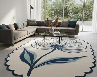 Alfombra de lana tejida a mano con borde festoneado floral y diseño botánico moderno.