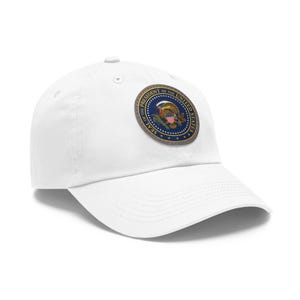 May include: White baseball cap featuring a circular patch with the official seal of the President of the United States. The patch is blue, gold, and red. The cap is made of a durable fabric and has a curved brim.