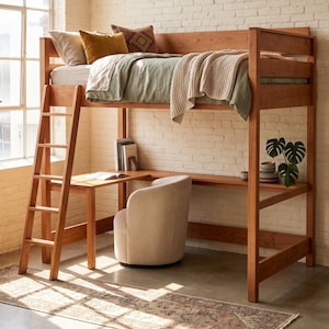 May include: A wooden loft bed frame with an integrated L-shaped desk underneath, featuring a ladder on the left side. The bed is dressed with a sage green duvet, a beige knit throw, and three decorative pillows. A cream-colored swivel chair sits at the desk.