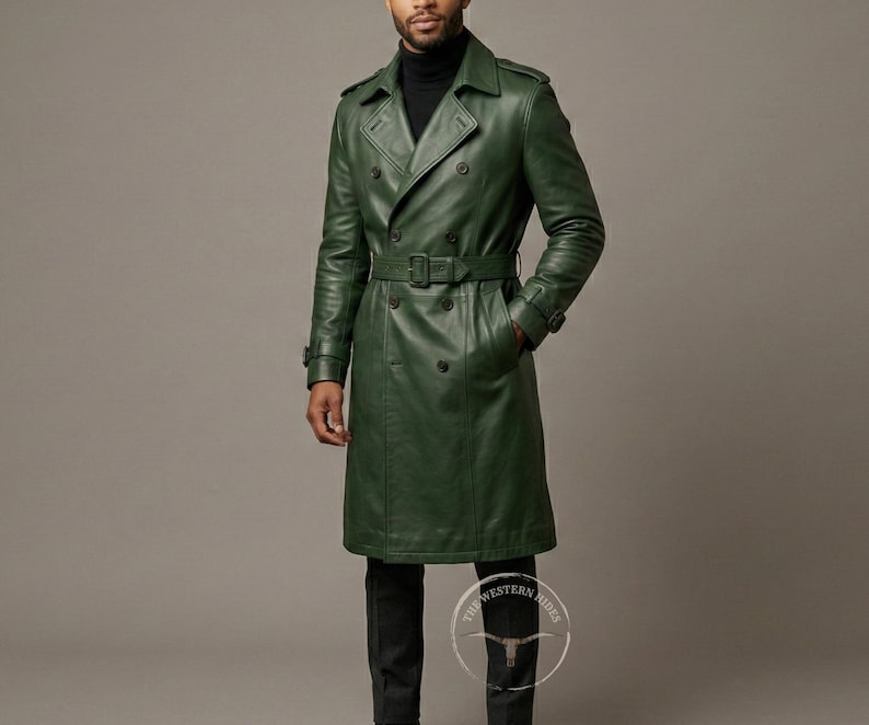 May include: A long, forest green leather trench coat with a double-breasted design, a belt at the waist, and a classic collar. The coat has a knee-length hem and is worn with black pants.