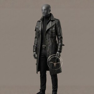 May include: A black leather trench coat with multiple pockets, a belt, and a high collar. The coat is worn over a black turtleneck and pants. The mannequin is wearing black gloves. The coat has the text "THE WESTERN RIDES" on the lower right side.