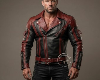 May include: Black and burgundy leather jacket with a classic biker style. Features a notched collar, zip pockets, and a belt at the waist. The jacket has a two-tone design with burgundy accents on the shoulders, sleeves, and collar.