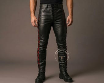 May include: Black leather pants with red lacing details on the sides and front. The pants have a lace-up closure and are worn with black boots. The Western Hide logo is visible.