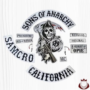 May include: A collection of embroidered patches featuring the words "SONS OF ANARCHY", "SAMCRO", and "CALIFORNIA". The central patch depicts a grim reaper holding a rifle. Additional patches include "PRESIDENT", "MEN OF MAYHEM", "REDWOOD", "ORIGINAL", "IN MEMORY OF OPIE", and "MC".