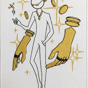 May include: A rectangular embroidered patch featuring a white stick figure wearing gold-coloured sunglasses, a necklace, and floating gold coins. Two large, detailed gold-coloured hands are positioned on either side, adorned with black rings and a star.