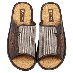 May include: A pair of brown leather and cork slippers. The slippers have a mesh fabric panel and the brand name "BELSTA" is visible in orange lettering. The soles are made of cork.