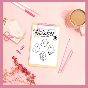 May include: A pink-themed Halloween-themed flat lay featuring a clipboard with the word "October" and ghost illustrations. Other items include a cup of coffee, pens, scissors, and paperclips.