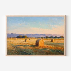 May include: An oil painting depicting a golden field with multiple round hay bales under a clear blue sky. In the background, a range of purple-toned mountains stretches across the horizon, with soft sunlight casting long shadows over the landscape.