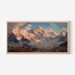 May include: A framed landscape painting depicting a snow-capped mountain range under a soft, golden-hued sky. The foreground features a rocky terrain with colorful prayer flags strung across the scene, partially obscured by low-hanging clouds.