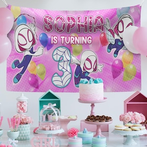 May include: A pink birthday banner with the text "SOPHIA IS TURNING 3" and Spider-Gwen characters. The party scene includes balloons, a cake, and decorations in pink, blue, and white, suitable for a third birthday.
