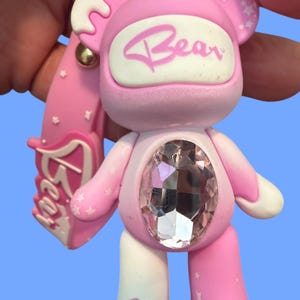 May include: A set of three ceramic mugs with a speckled, matte finish. The mugs are in shades of cream, light gray, and dark gray. Each mug has a simple, minimalist design, perfect for coffee or tea.