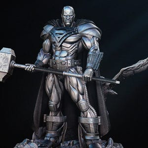May include: A silver statue of a superhero figure, holding a large hammer and a weapon with a wing design. The figure wears a cape and armour with the Superman logo. The statue is on a rocky base.