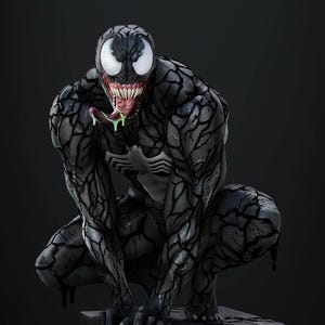 May include: A detailed statue of Venom, a Marvel Comics character, in a crouching pose. The figure is predominantly black with white eyes, a large mouth filled with teeth, and a long, green tongue. The statue is on a stone base.