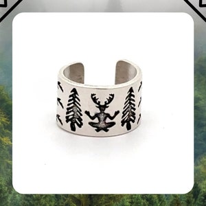 May include: Silver ear cuff with a black silhouette of a person sitting in a meditative pose with trees on either side. The text "HANDMADE TO ORDER WITH LOVE, JUST FOR YOU" is below the image.