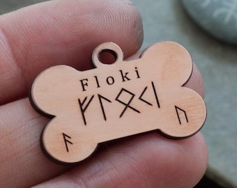 May include: A wooden dog tag shaped like a bone with the name "Floki" and runes engraved on it.
