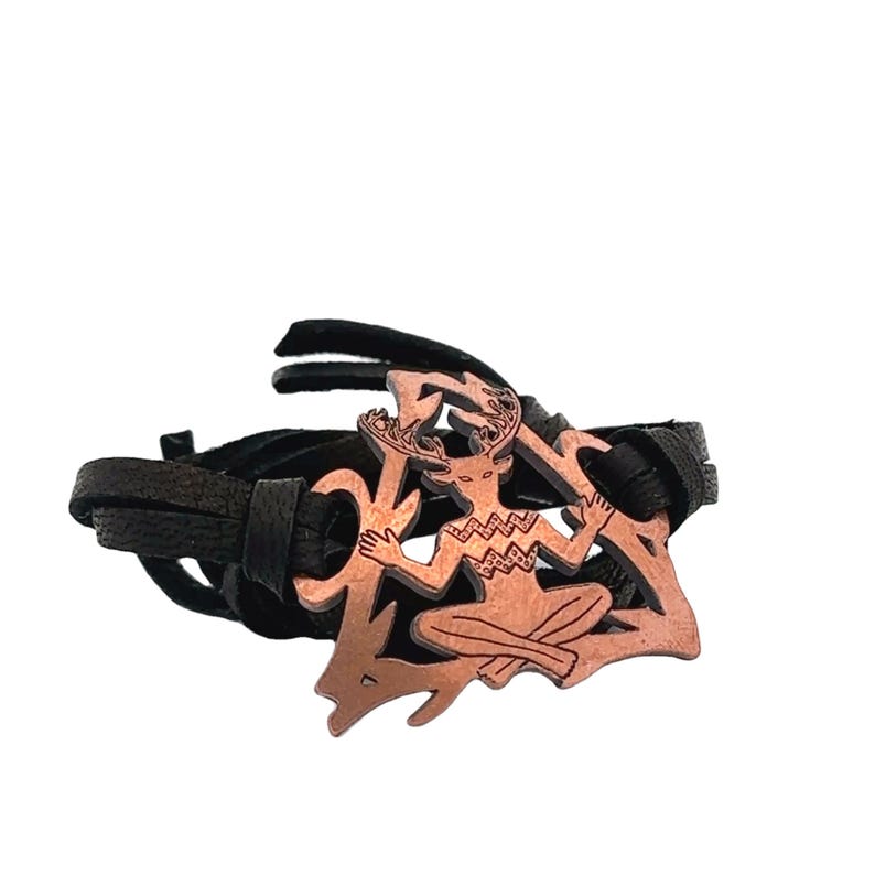 May include: A copper-colored bracelet with a leather strap and a Celtic knot design featuring a horned figure.