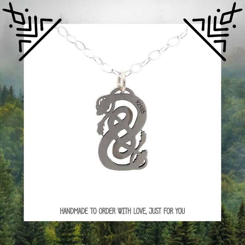 May include: A silver necklace with a pendant featuring a stylized knot design. The pendant is marked with "925SS" and the text "HANDMADE TO ORDER WITH LOVE, JUST FOR YOU".