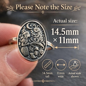 May include: Silver-toned ring with an oval pendant featuring an engraved scene with a girl, caterpillar, and mushroom. The ring is 14.5mm tall and 11mm wide. The text "Please Note the Size" and "Actual size" are visible.