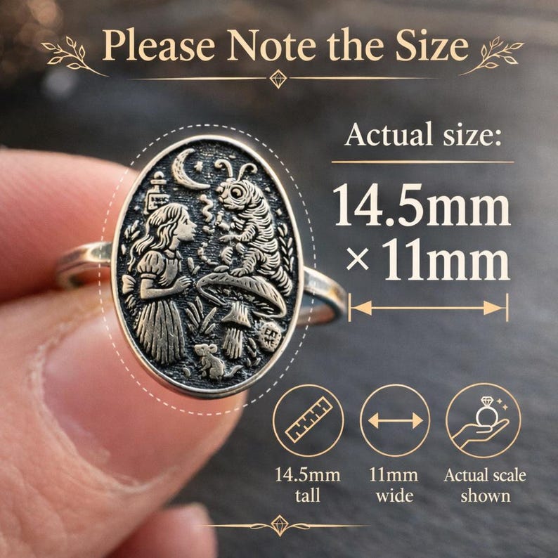 May include: Silver-toned ring with an oval pendant featuring an engraved scene with a girl, caterpillar, and mushroom. The ring is 14.5mm tall and 11mm wide. The text "Please Note the Size" and "Actual size" are visible.