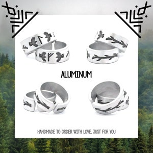May include: Three silver rings with different designs. The first ring has a bird and runes engraved on it. The second ring has a branch design. The third ring has a bird and arrow design. The rings are made of aluminum and are handmade to order.