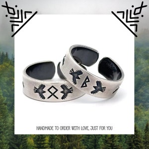 May include: Two silver adjustable rings with black etched designs. The rings feature a bird and a geometric symbol. The text "HANDMADE TO ORDER WITH LOVE, JUST FOR YOU" is visible below the rings.