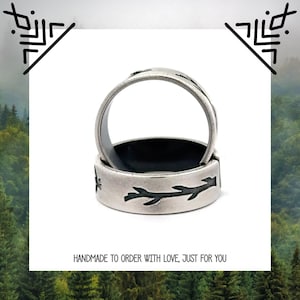May include: Two silver rings with a black branch design. The rings are stacked on top of each other. The text "HANDMADE TO ORDER WITH LOVE, JUST FOR YOU" is below the rings.