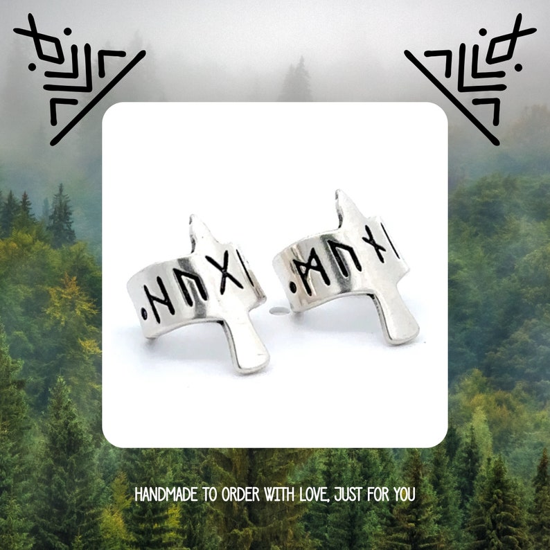 May include: A pair of silver ear cuffs with a rune inscription. The inscription reads "ANXI".