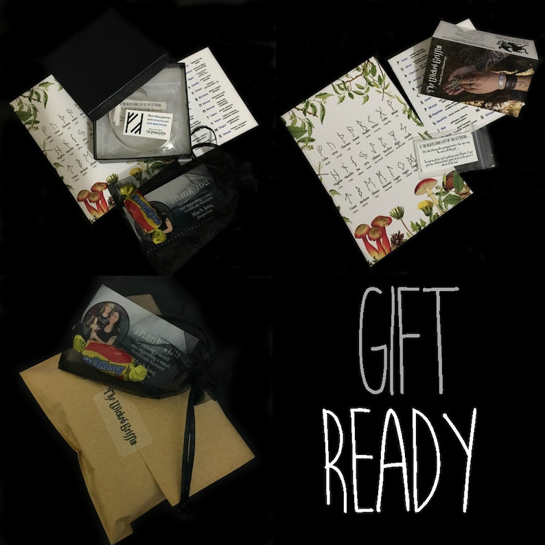 May include: Gift packaging with a black and white print of the Elder Futhark runes, a small black bag with a thank you card, a clear plastic bag with a silver ring, and a brown paper bag with a black and white illustration of a woman with a cat. The text "Gift Ready" is written in white on a black background.