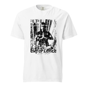 May include: White t-shirt featuring a black and white graphic of a person in a meditative pose. The word "experience" is printed in a bold, distressed font at the bottom of the graphic. The shirt is made of a soft, comfortable material.