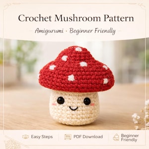Puede incluir: Un amigurumi de hongo tejido a crochet con un gorro rojo salpicado de puntos blancos y un tallo color crema. El hongo tiene una cara sonriente con ojos negros y mejillas rosadas. El texto dice "Crochet Mushroom Pattern - Amigurumi - Beginner Friendly."