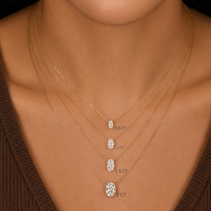 May include: Four gold necklaces, each featuring a single oval-cut white gemstone pendant. The pendants are labeled 0.5 CT, 1 CT, 1.5 CT, and 2 CT, indicating their respective sizes. Each necklace consists of a delicate gold chain.