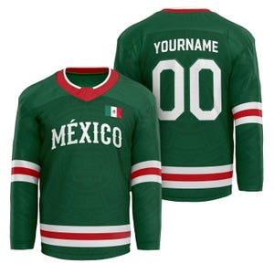 May include: A green hockey jersey with white and red detailing. The jersey displays the word "MÉXICO" in white, a Mexican flag, and the number "00" on the back. The jersey has a V-neck collar with red trim and white stripes.