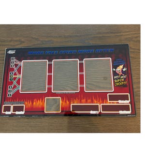 May include: A rectangular WMS gaming machine glass panel featuring a red and black flame design. It displays the text MORE FREE SPINS MORE OFTEN and HOT HOT SUPER JACKPOT with a cartoon flame character. Includes three large rectangular frames.
