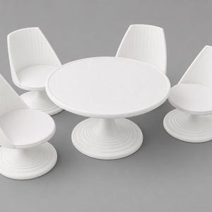 May include: A white miniature dining set consisting of a circular pedestal table and three matching chairs. Each piece features a smooth, solid white finish with a ribbed base design and a clean, uniform appearance for a dollhouse furniture display.