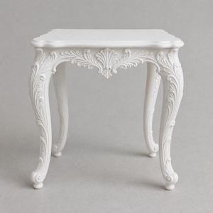 May include: A square white side table featuring intricate carved scrollwork and acanthus leaf detailing along the apron and four curved cabriole legs. The table has a smooth, flat top surface and a uniform matte white finish throughout the structure.