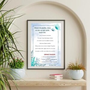 May include: A framed print with German text, featuring a light blue watercolor design with butterflies and botanical elements. The text reads "Wenn ich merke, dass es mir zu viel wird, kann ich:" and "DENKE DARAN:" on a white background.